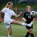 Skyline sophomore Gretchen Bakker-Arkema kicks the ball over Huron junior Genevieve Sponseller on Thursday, May 30. Daniel Brenner I AnnArbor.com